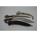 A mid-20th century kukri knife in leather scabbard and a further 20th century Eastern knife with