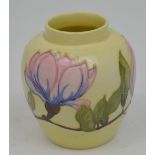 A Moorcroft jar, tube-lined decoration, painted and glazed with pink magnolias over a cream ground,