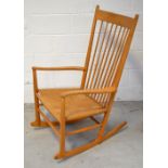 Hans Wegner for F D B Mobler; a retro stick back rocking chair with rush seat,