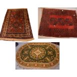 A traditional rug with complex design on a red ground, approx 178 x 113cm,