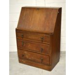 A 20th century oak bureau with fitted interior and three drawers, width 80cm.