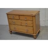 An Edwardian pine two-over-three chest of drawers on baluster support,