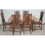 An early 20th century oak dining table on baluster supports to stepped base and cross stretcher,