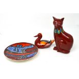 Three pieces of Poole to include a Delphis cat, height 29cm, a duck and a decorative wall plate (3).