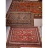 An Chinese burnt orange ground rug with cream and blue geometric design, 237 x 146cm,