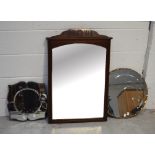 An Edwardian mahogany rectangular wall mirror with decorative frieze to the top,