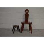 A small hardwood hall style chair with gilt metal crucifix insert and a rustic milking stool (2).