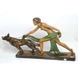 A large Art Deco figurine of a naked maiden with a wolfhound on a chain, length 73cm.