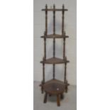 An early 20th century mahogany three-tier whatnot on turned supports and squat cabriole legs,