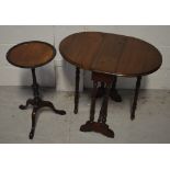 A mahogany drop-leaf table of small proportions, raised on turned supports with castors,