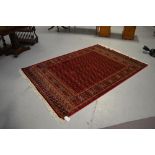 A red ground Bokhara carpet, 230 x 160cm.