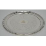 A hallmarked silver salver with coat of arms to the centre, marks rubbed, diameter 28cm,