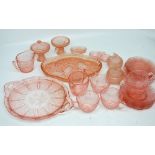 A peach coloured glass dressing table set and a quantity of similar glass teaware.