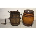 Two large barrels, a wooden example with metal banding and metal handle,