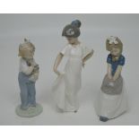 Three Nao figures; a young girl holding her dress,