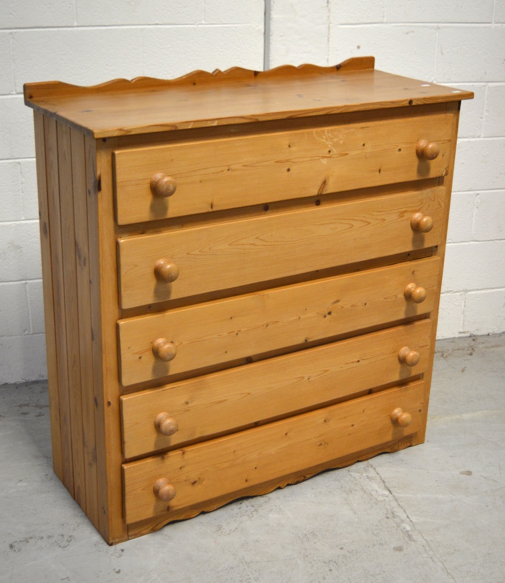 A contemporary pine chest of five long drawers with shaped upstand, width approx 110cm.