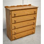 A contemporary pine chest of five long drawers with shaped upstand, width approx 110cm.