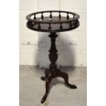 A reproduction mahogany tripod wine table, galleried and raised on a turned pedestal, diameter 40cm.