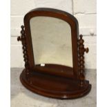 A mid-Victorian mahogany tabletop swing mirror, raised on bobbin supports on demi-lune base,