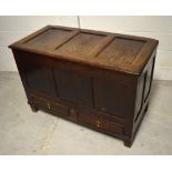 An 18th century oak blanket chest, panelled hinged top above long lower drawer to block supports,