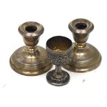 A pair of Elizabeth II hallmarked silver loaded squat candlesticks,