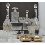 A pair of cut glass decanters, two further decanters,