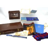 A leather case containing a quantity of Masonic regalia to include gloves, apron, sash etc,