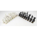 A Franklin Mint black and white porcelain "Chess Set of The Gods", with gilt highlights,