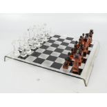 A 20th century acrylic chess set and board, boxed.