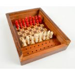 An early 19th century bone piece travelling chess set, a walnut and boxwood inlaid board,