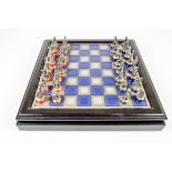 A pewter Napoleon and Wellington chess set with board, boxed.