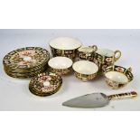 A Royal Crown Derby Imari decorated part dessert set comprising a set of eight plates,