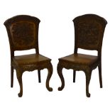 A pair of decorative Chinese inspired carved hall chairs with serpentine seats with cabriole front