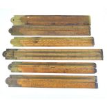 A group of six simple boxwood and brass mounted two sectioned folding rules,