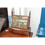 An early 19th century mahogany swing toilet mirror on three drawer bowfronted base, width 48cm.