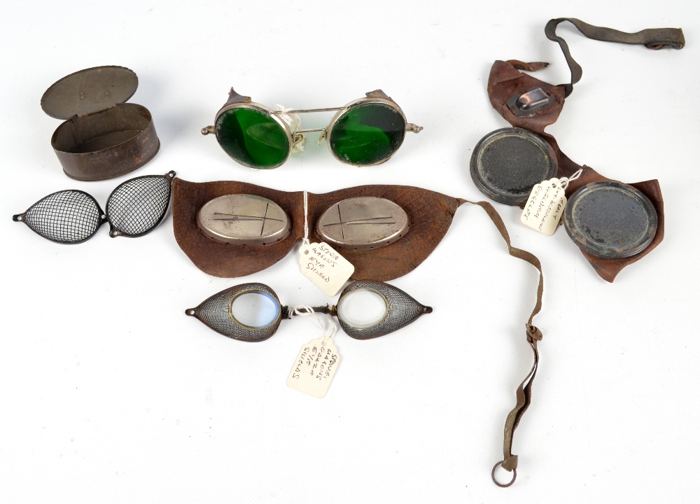 Two pairs of goggles to include one with green lenses,