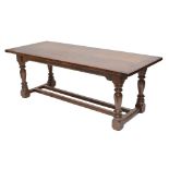 A reproduction oak refectory table with ring turned stretchered supports, 213 x 86cm.