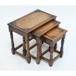 A nest of three oak occasional tables with ring turned stretchered support,