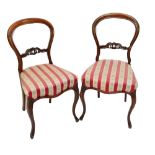 A set of four Victorian rosewood balloon back salon chairs on cabriole legs.