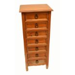 A pine narrow chest of seven drawers, height 115cm, top 48.9 x 43cm.