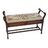 An Edwardian walnut piano duet stool with floral woolwork seat,