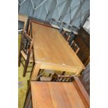 A large contemporary two drawer refectory type table with shaped undertier and square section legs.