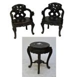 A set of four ebonised Chinese inspired elbow tub chairs with carved dragon detail,