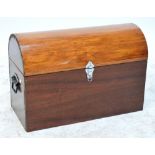 A pine and mahogany trunk with dome hinged lid and twin handles, 68.5 x 32cm, height 47cm.