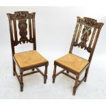 A set of four late 19th/early 20th century carved oak rush seated dining chairs.