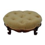 A Victorian walnut oval button upholstered foot stool on scrolling feet 39.5 x 32cm.