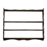 A set of oak wall mounted shelves with pierced and shaped ends,