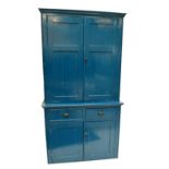 A blue painted pine two door bookcase on associated cupboard,