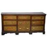 A George III oak and mahogany crossbanded dresser,