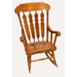 A reproduction oak rocking chair.